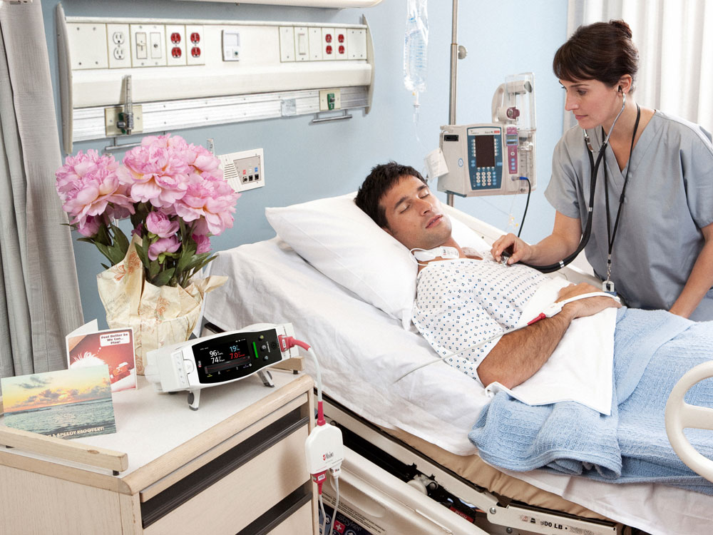 Crying infant in incubator in neonatal intensive care unit.